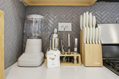a kitchen counter with a blender and a knife block at Sleeps 8, Fire pit, Near DIA & Downtown Denver in Commerce City
