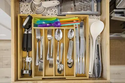 a wooden drawer with utensils in a kitchen at Sleeps 8, Fire pit, Near DIA & Downtown Denver in Commerce City