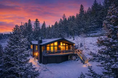 a house in the middle of a snow covered forest at Luxury Mountain Views, hot tub, peaceful retreat in Black Hawk