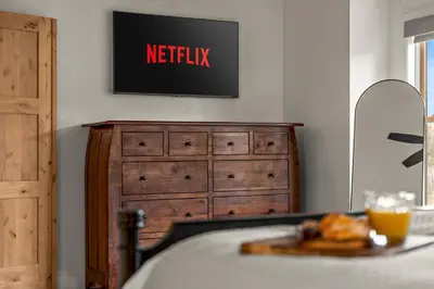 a television on a wall above a dresser at Luxury Mountain Views, hot tub, peaceful retreat in Black Hawk