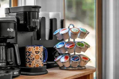 a group of cups on a counter next to a coffee maker at Luxury Mountain Views, hot tub, peaceful retreat in Black Hawk