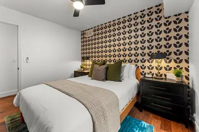 a bedroom with a bed and a wall with a pattern at Luxury Mountain Views, hot tub, peaceful retreat in Black Hawk