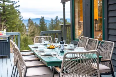 a green table with chairs on a patio at Luxury Mountain Views, hot tub, peaceful retreat in Black Hawk