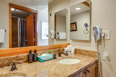 a bathroom with a sink and a mirror at Continental Divide Views Lakefront Keystone Condo in Keystone