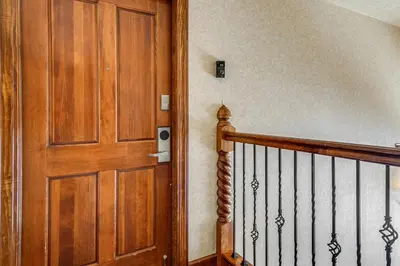 a hallway with a wooden door and a staircase at Continental Divide Views Lakefront Keystone Condo in Keystone