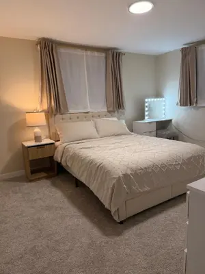 a bedroom with a large bed and two night stands at Stylish 4BR Getaway, Foosball, Easy Highway Access in Westminster