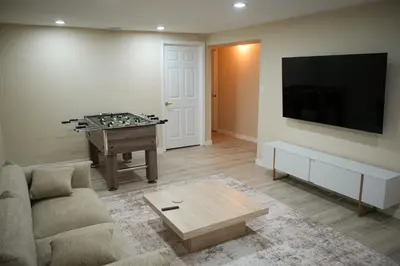 a living room with a couch and a table at Stylish 4BR Getaway, Foosball, Easy Highway Access in Westminster