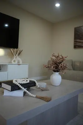 a living room with a table with a book and a vase at Stylish 4BR Getaway, Foosball, Easy Highway Access in Westminster