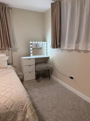 a bedroom with a bed and a desk with a mirror at Stylish 4BR Getaway, Foosball, Easy Highway Access in Westminster