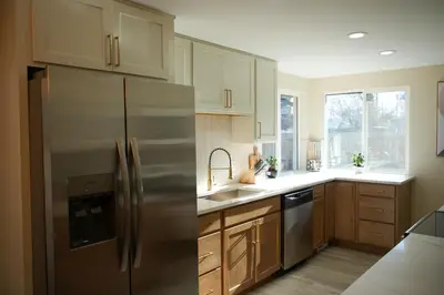 a kitchen with a stainless steel refrigerator and wooden cabinets at Stylish 4BR Getaway, Foosball, Easy Highway Access in Westminster
