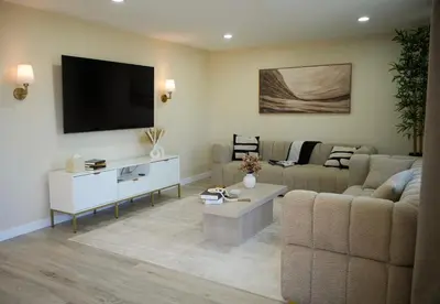 a living room with a couch and a tv on the wall at Stylish 4BR Getaway, Foosball, Easy Highway Access in Westminster