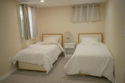 a bedroom with two beds and a window at Stylish 4BR Getaway, Foosball, Easy Highway Access in Westminster
