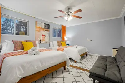 a bedroom with three beds and a ceiling fan at Family Fun Retreat - Hot Tub & Games in Arvada