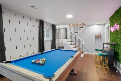 a pool table in a room with a staircase at Family Fun Retreat - Hot Tub & Games in Arvada
