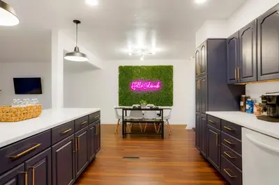 a kitchen with purple cabinets and a table in it at Family Fun Retreat - Hot Tub & Games in Arvada