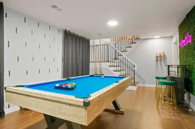 a pool table in a room with a staircase at Family Fun Retreat - Hot Tub & Games in Arvada