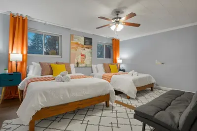 a bedroom with two beds and a ceiling fan at Family Fun Retreat - Hot Tub & Games in Arvada