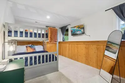 a bedroom with a bunk bed and a desk at 15 min to Boulder Rope Course Hot Tub & Views in Boulder
