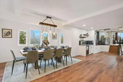 a dining room and living room with a table and chairs at 15 min to Boulder Rope Course Hot Tub & Views in Boulder