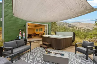 a living room with a hot tub and a patio at 15 min to Boulder Rope Course Hot Tub & Views in Boulder