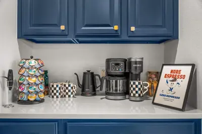 a kitchen counter with a coffee maker and coffee cups at Huge Lodge w Pickleball & More 15 mins to Golden in Arvada