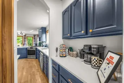 a kitchen with blue cabinets and a counter top at Huge Lodge w Pickleball & More 15 mins to Golden in Arvada