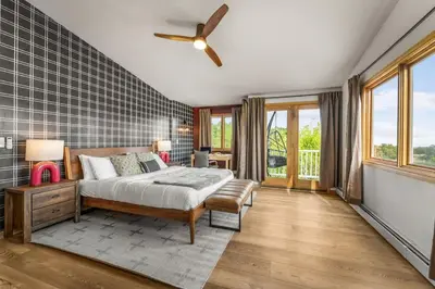 a bedroom with a bed and a ceiling fan at Huge Lodge w Pickleball & More 15 mins to Golden in Arvada