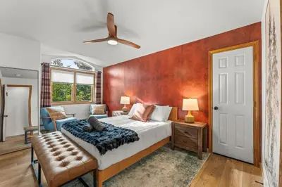 a bedroom with a large bed and a ceiling fan at Huge Lodge w Pickleball & More 15 mins to Golden in Arvada