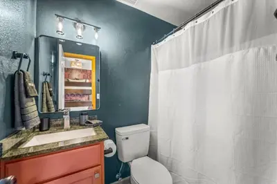 a bathroom with a toilet and a sink and a shower at Huge Lodge w Pickleball & More 15 mins to Golden in Arvada