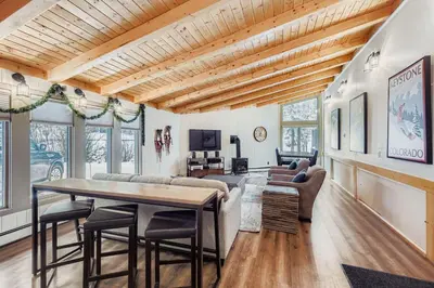 a living room with a table and some chairs at 2963 Key Condo condo in Keystone