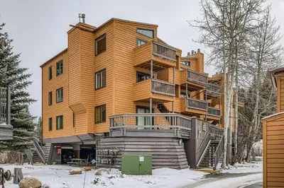 a large wooden building in the snow at 2963 Key Condo condo in Keystone