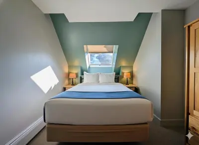 a bedroom with a bed with two lamps and a window at Silver Mill 8299 by SummitCove Lodging in Keystone