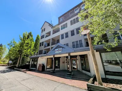 a tall building with a sign on the front of it at Silver Mill 8299 by SummitCove Lodging in Keystone