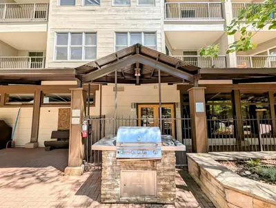 a patio with a grill in front of a building at Silver Mill 8299 by SummitCove Lodging in Keystone