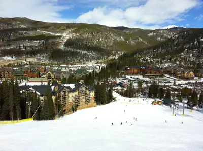 a group of people skiing down a snow covered slope at Silver Mill 8299 by SummitCove Lodging in Keystone