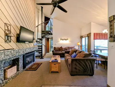 a living room with a couch and a fireplace at Flying Dutchman 1109 by SummitCove Lodging in Keystone