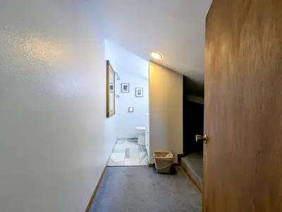 a hallway with a door leading to a bathroom at Flying Dutchman 1109 by SummitCove Lodging in Keystone