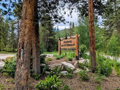 a sign for a hiking program in a forest at Flying Dutchman 1109 by SummitCove Lodging in Keystone