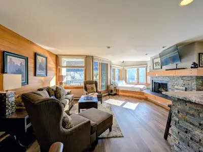 a living room with a couch and a fireplace at Lakeside 1491 by SummitCove Lodging in Keystone