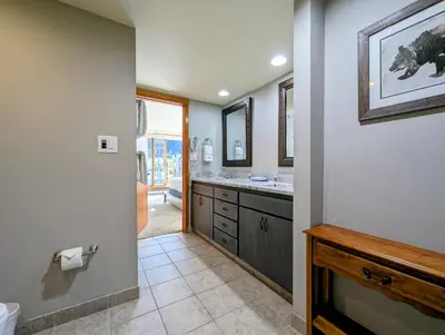 a bathroom with a sink and two sinks and a mirror at Lakeside 1491 by SummitCove Lodging in Keystone