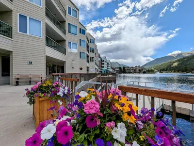 a bunch of flowers in a wooden box next to a building at Lakeside 1491 by SummitCove Lodging in Keystone