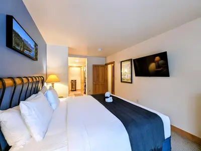 a bedroom with a large white bed with white pillows at Expedition Station 8591 by SummitCove Lodging in Keystone