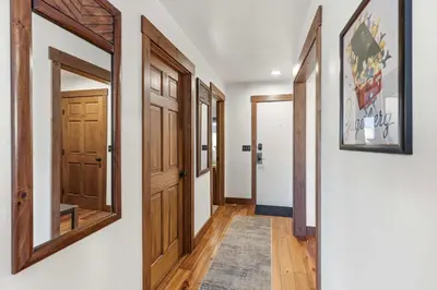 a hallway with wooden doors and a rug at 2BR Escape for 6 Overlooking Marina & Lake Dillon in Dillon