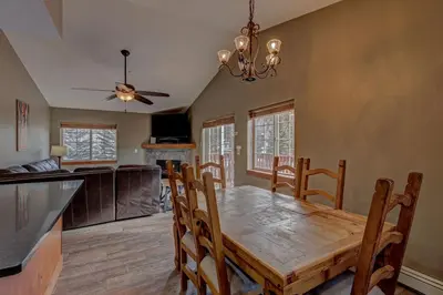 a kitchen and dining room with a wooden table and chairs at Breckenridge 2BR Ski and Mountain Adventure Base in Breckenridge