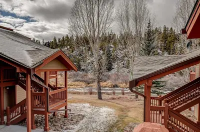 a couple of wooden homes with snow on the ground at Breckenridge 2BR Ski and Mountain Adventure Base in Breckenridge