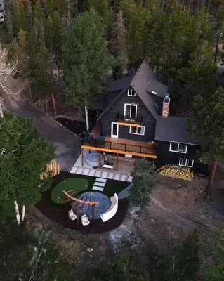 an aerial view of a large house with a yard at Modern Chalet w Hot Tub, Views, Putting Green in Evergreen