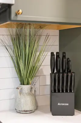 a vase with a plant sitting next to a knife block at Modern Chalet w Hot Tub, Views, Putting Green in Evergreen