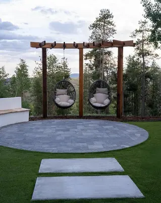 a circular patio with two chairs and a pergola at Modern Chalet w Hot Tub, Views, Putting Green in Evergreen