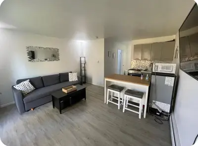 a living room and kitchen with a couch and a table at My hidden gem in Denver