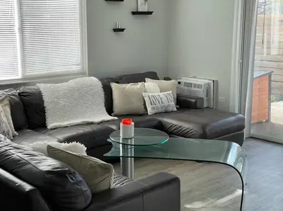 a living room with a leather couch and a glass table at Lovely 2 bedroom unit with a hot tub Pet friendly in Denver